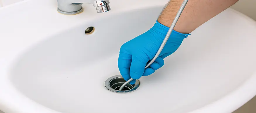 Plumber Cleaning a Clogged Drain in Sugar Land | Professional & Thorough